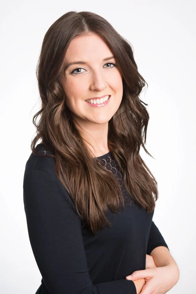 Dr. Lindsay Kellington, naturopath in a black top posing for a photo.