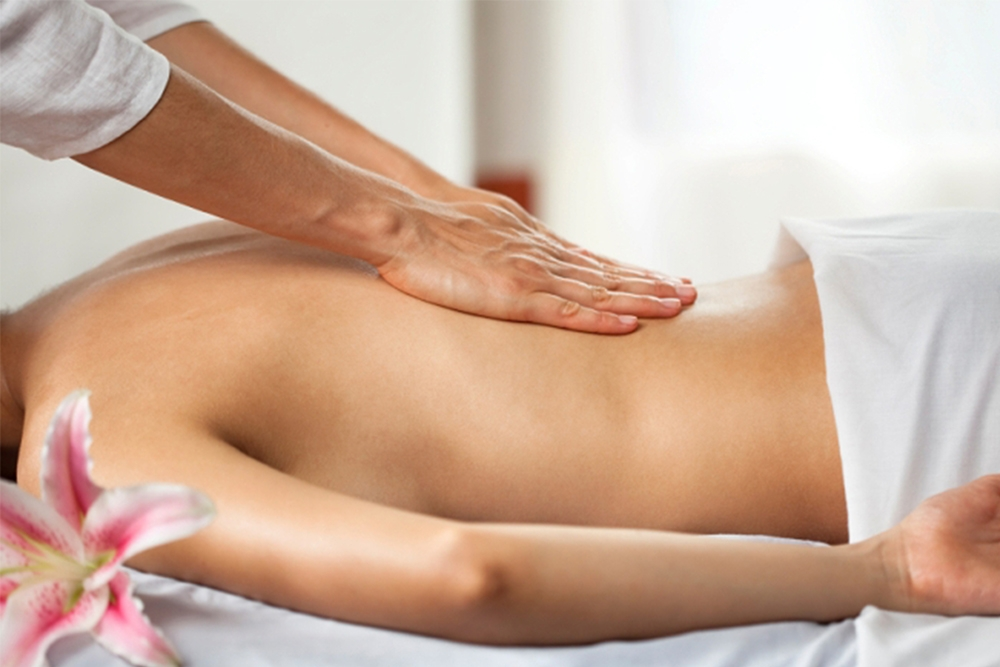 A woman receiving massage therapy at a spa.