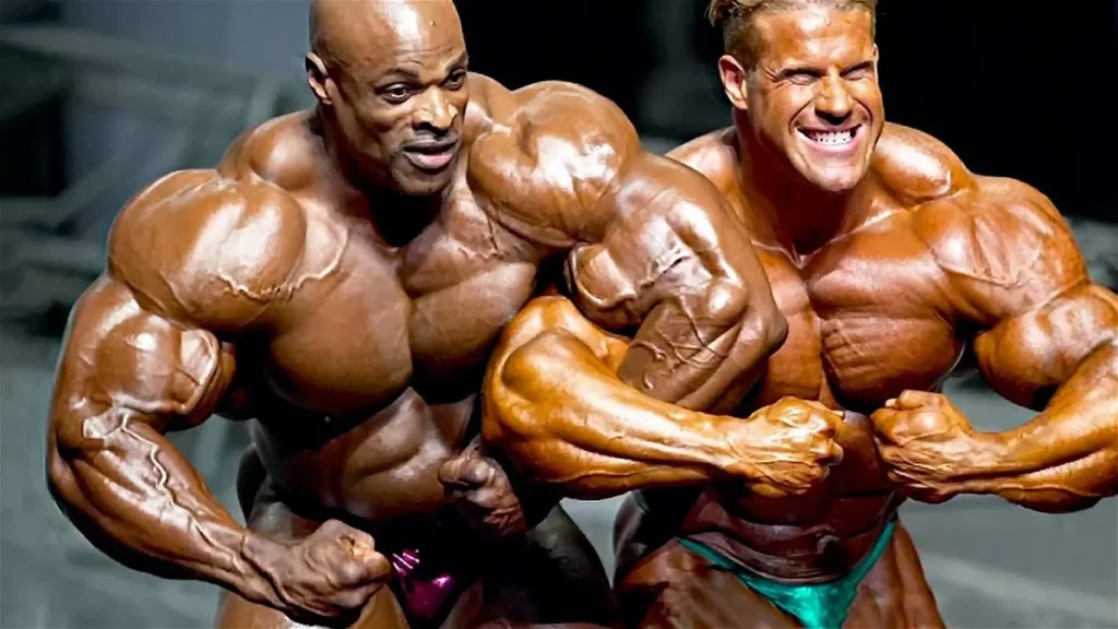 Two bodybuilders showcasing their impressive physique for the camera in a classic bodybuilding pose.