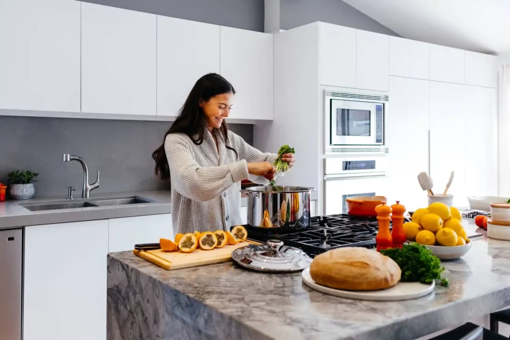 A woman is preparing healthy food in a kitchen for a living.