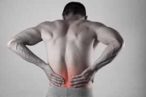 A man always holding his back due to back pain.