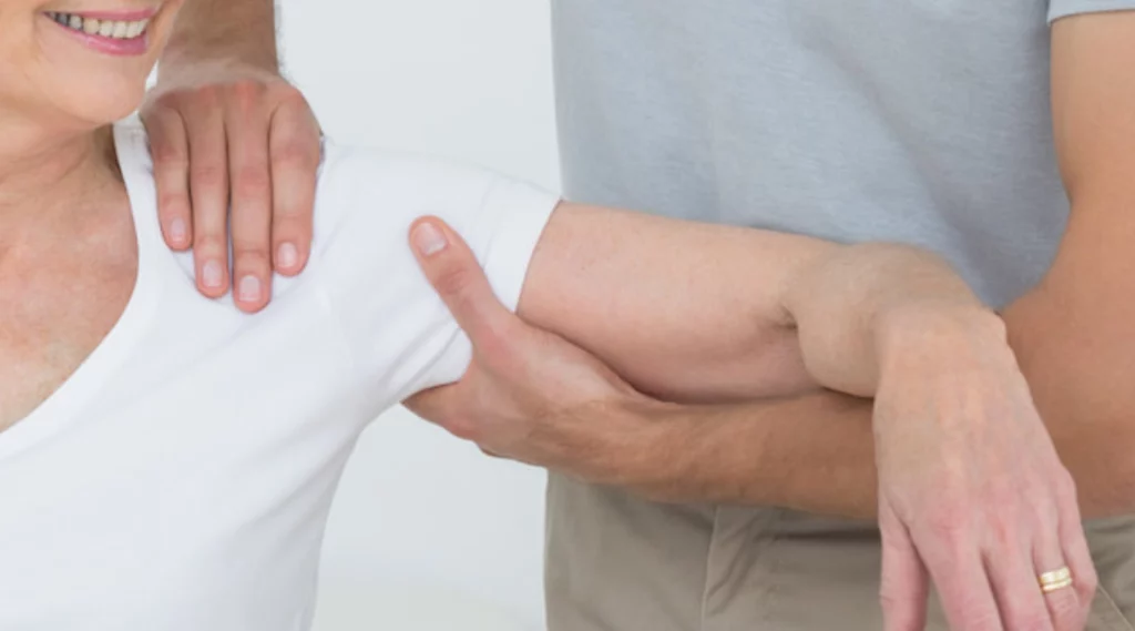 A woman is receiving physiotherapy to help with shoulder pain relief.